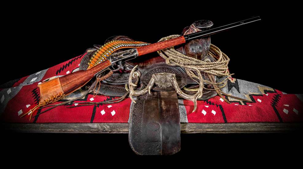 Cimarron Firearms 40th Anniversary set with lever-action rifle horse saddle bandolier