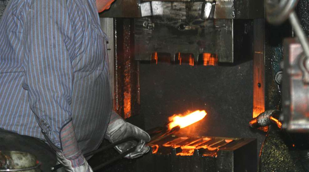 Smith & Wesson forge man yellow orange steel forging parts manufacturing