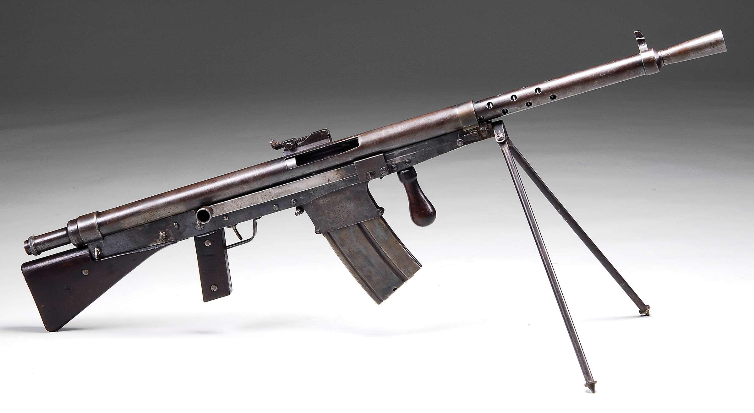 Right-side view on white and gray background of an example of the .30-&#x27;06 Sprg. caliber Fusil Mitrailleur Modéle 1918 CSRG Chauchat Light Machine Gun with the different magazine and verticle foregrip location. (Photograph courtesy of  James D. Julia Auctioneers)