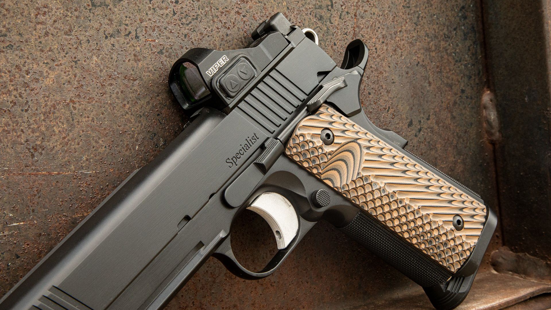 A close-up of the Dan Wesson 1911 Specialist Optics-Ready controls shown on a stone background.