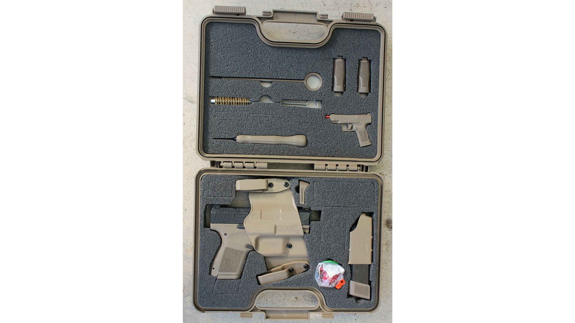 Canike Mete MC9 pistol case shown open with accessories foam inserts gun box storage loack brush tools magazine