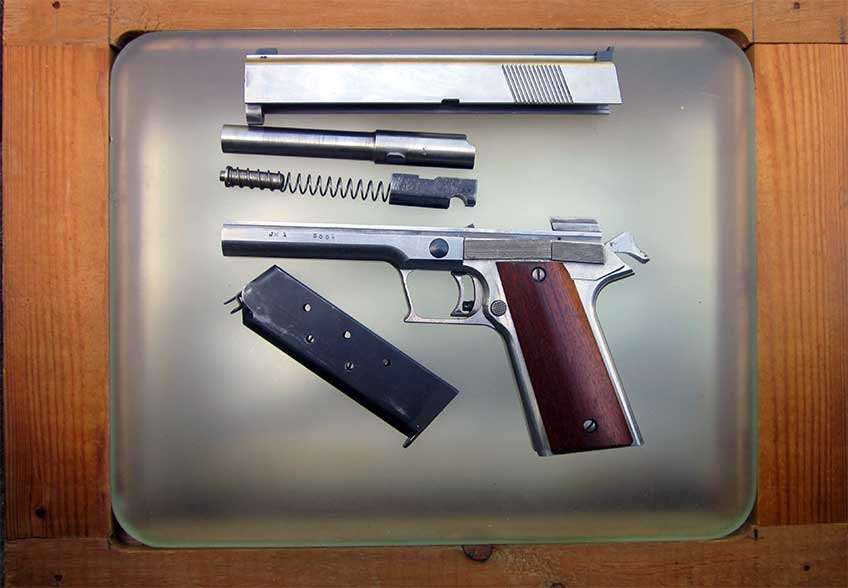 The Excalibur prototype shown field-stripped on a glass block.