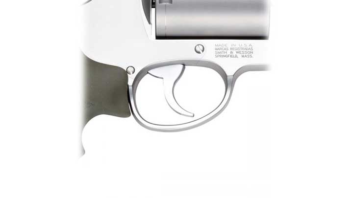 Trigger guard and trigger of the Smith &amp; Wesson 460XVR revolver shown on white.