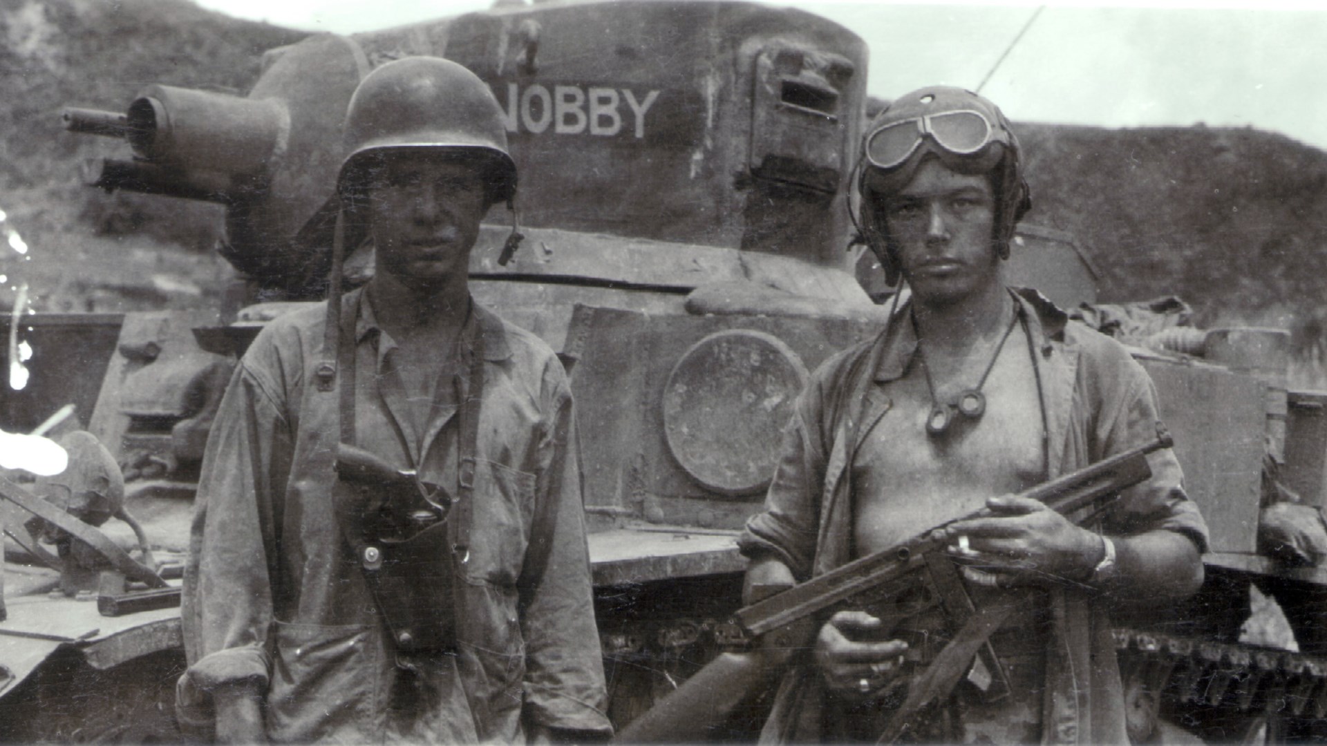 Crew members of “Nobby”, a USMC M3A1 “Satan” flame-throwing tank on Saipan, June 1944. The Marine at left carries a M1917 .45 caliber revolver, while the Leatherneck at right has a .45 caliber M1A1 Thompson SMG