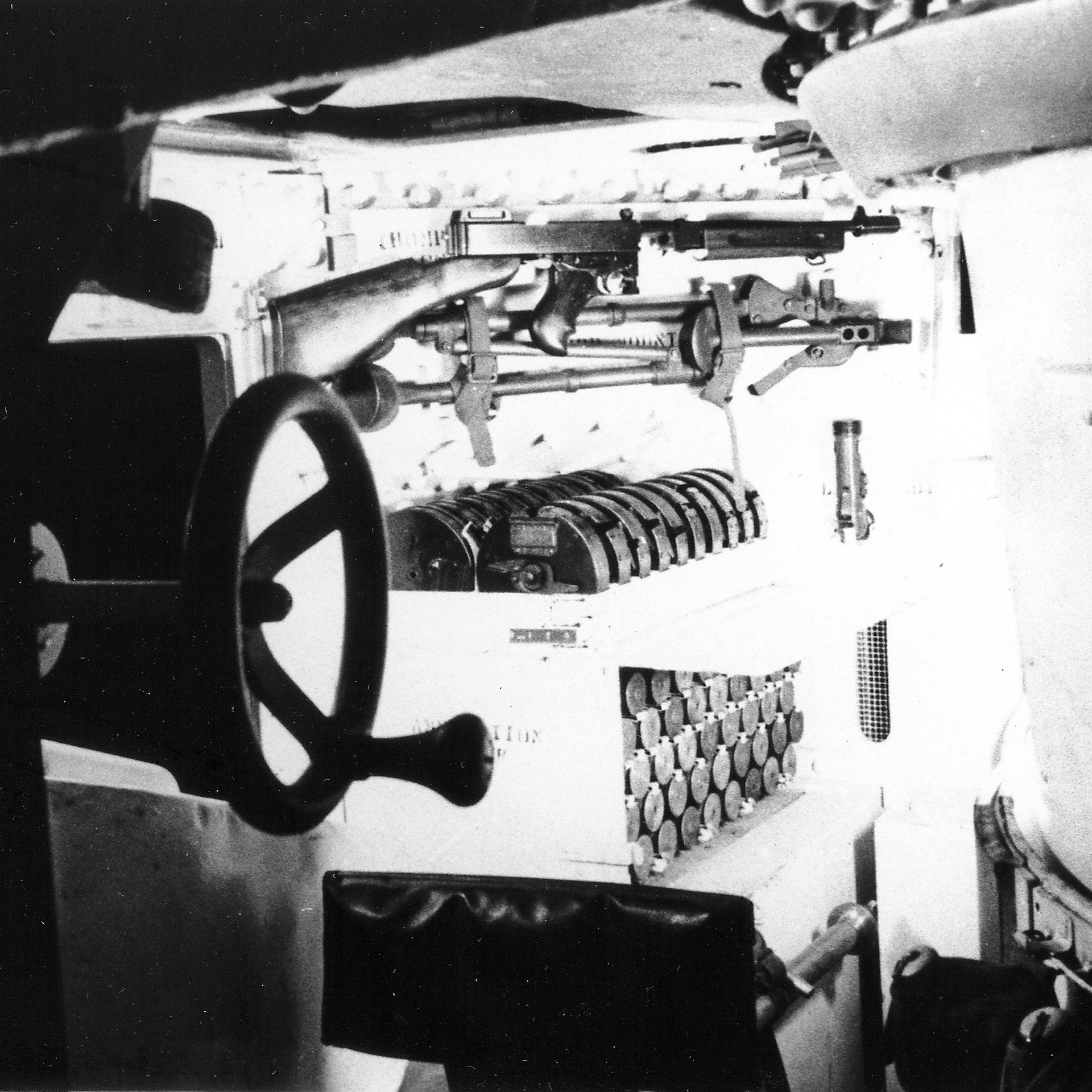 The interior of a M3 Lee medium tank, showing storage for a M1928 Thompson SMG. Note the twenty 50-round drum magazines for the Thompson gun