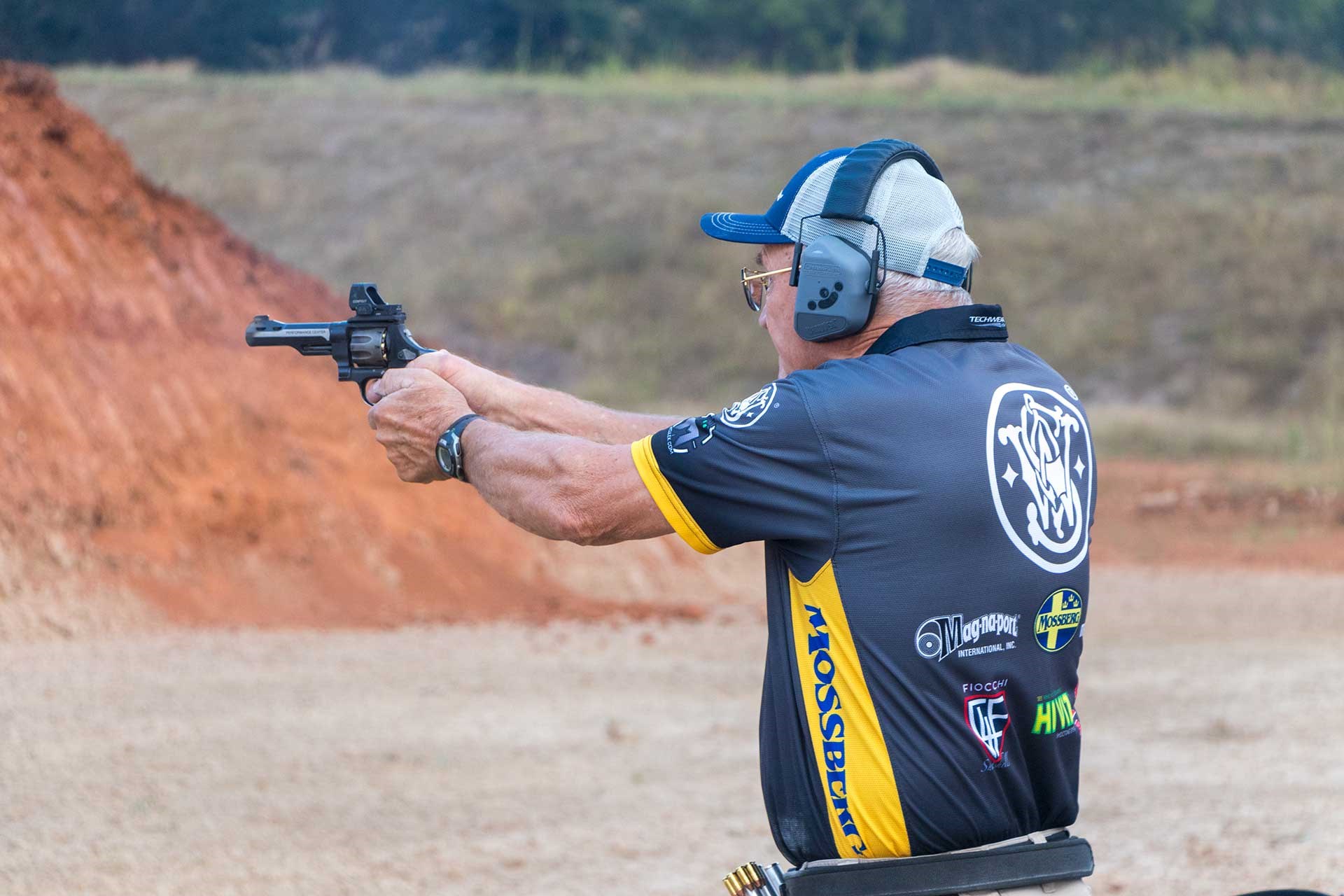 Professional shooter Jerry Miculek aims a revolver downrange.