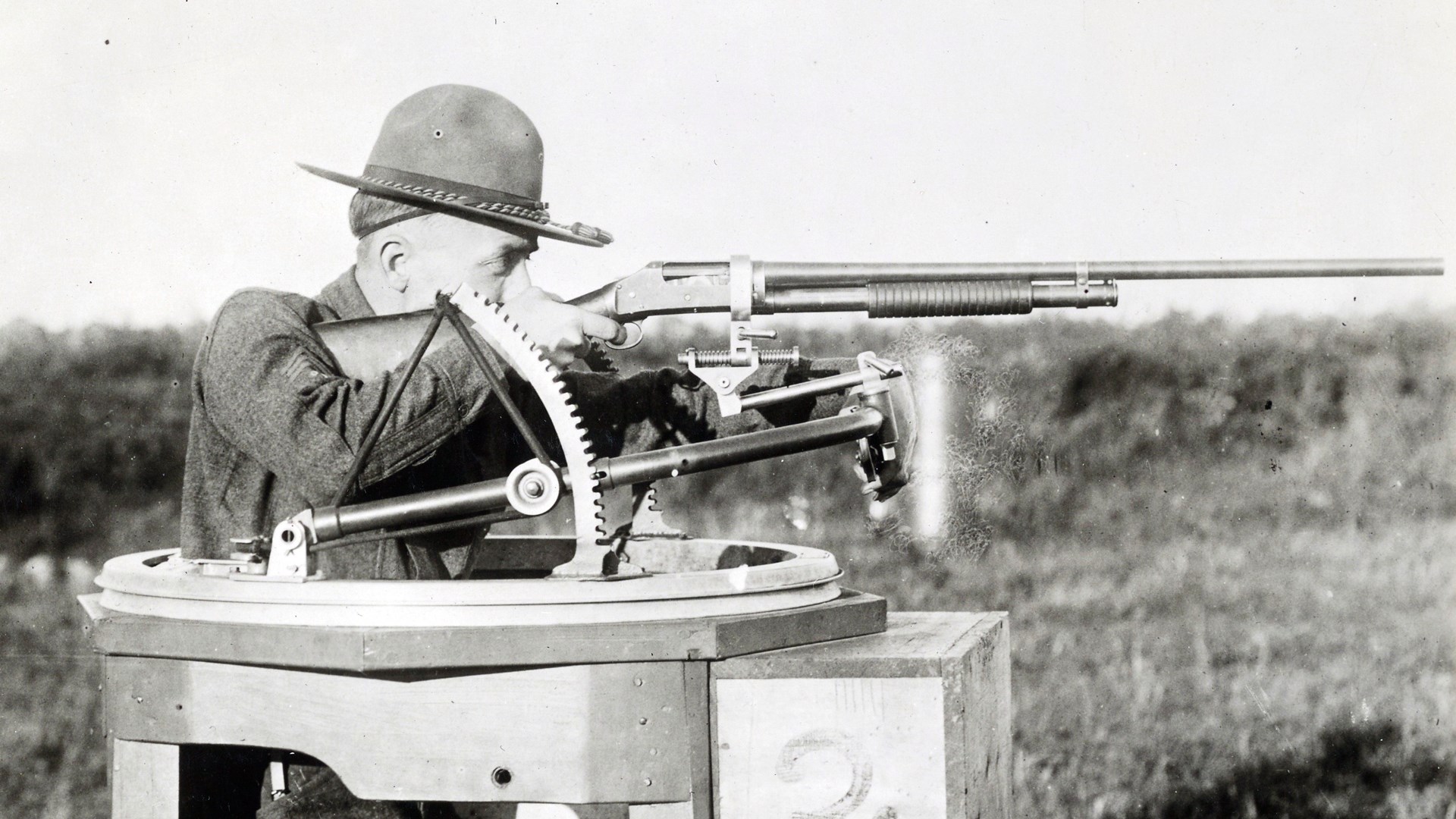 A trainee in a special turret stand equipped with a Scarff mount—featuring a special adapter to attach a Winchester Model 1897 shotgun. Selfridge Field, Mich., 1918.
