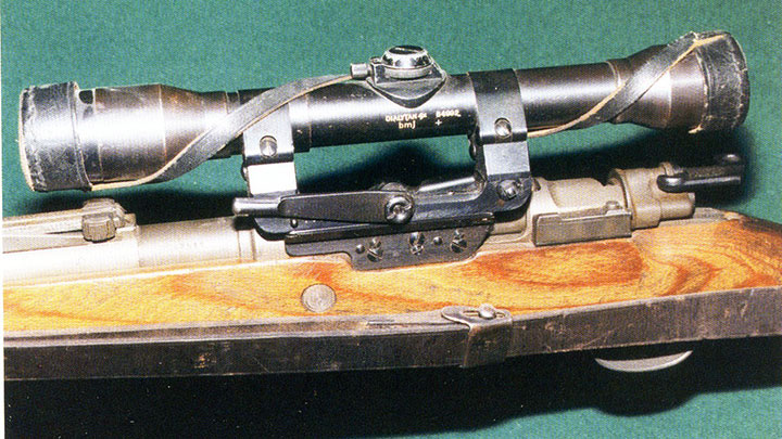 A long-side rail with the Dialytan sight and its leather lens covers.  The difference in length between this and the short mount is clearly visible.