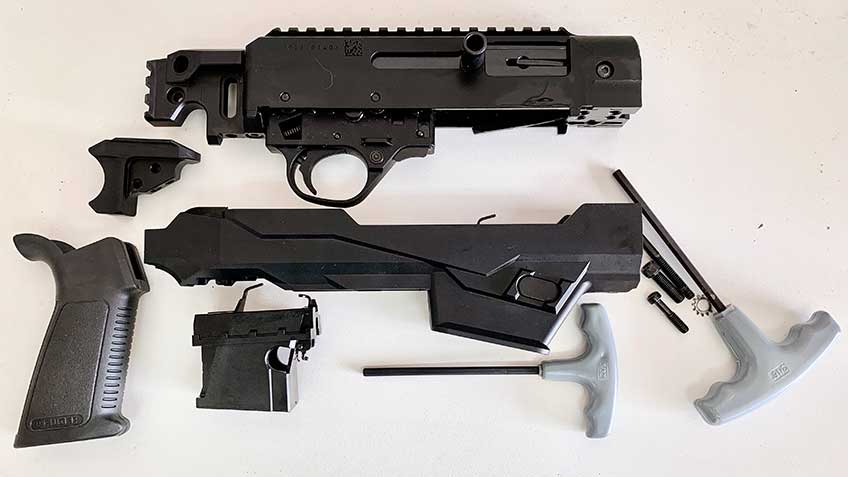 Ruger PC Charger pistol fully disassembled on table with parts laid out.