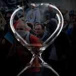 hourglass with protesters