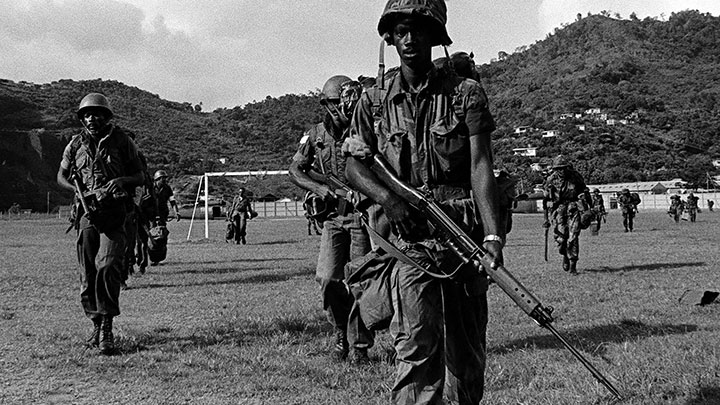 Urgent Fury was a multi-national operation. Men of the Eastern Caribbean Defense Force help secure the island. The soldier in the foreground carries the FN FAL rifle (7.62 NATO) while the man to left holds a Sterling submachine gun (9 mm).