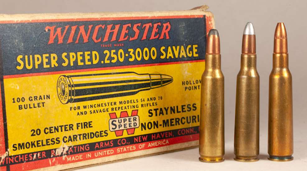 Winchester SUper Speed .250-3000 Savage ammunition box shown next to upright brass rifle cartridges