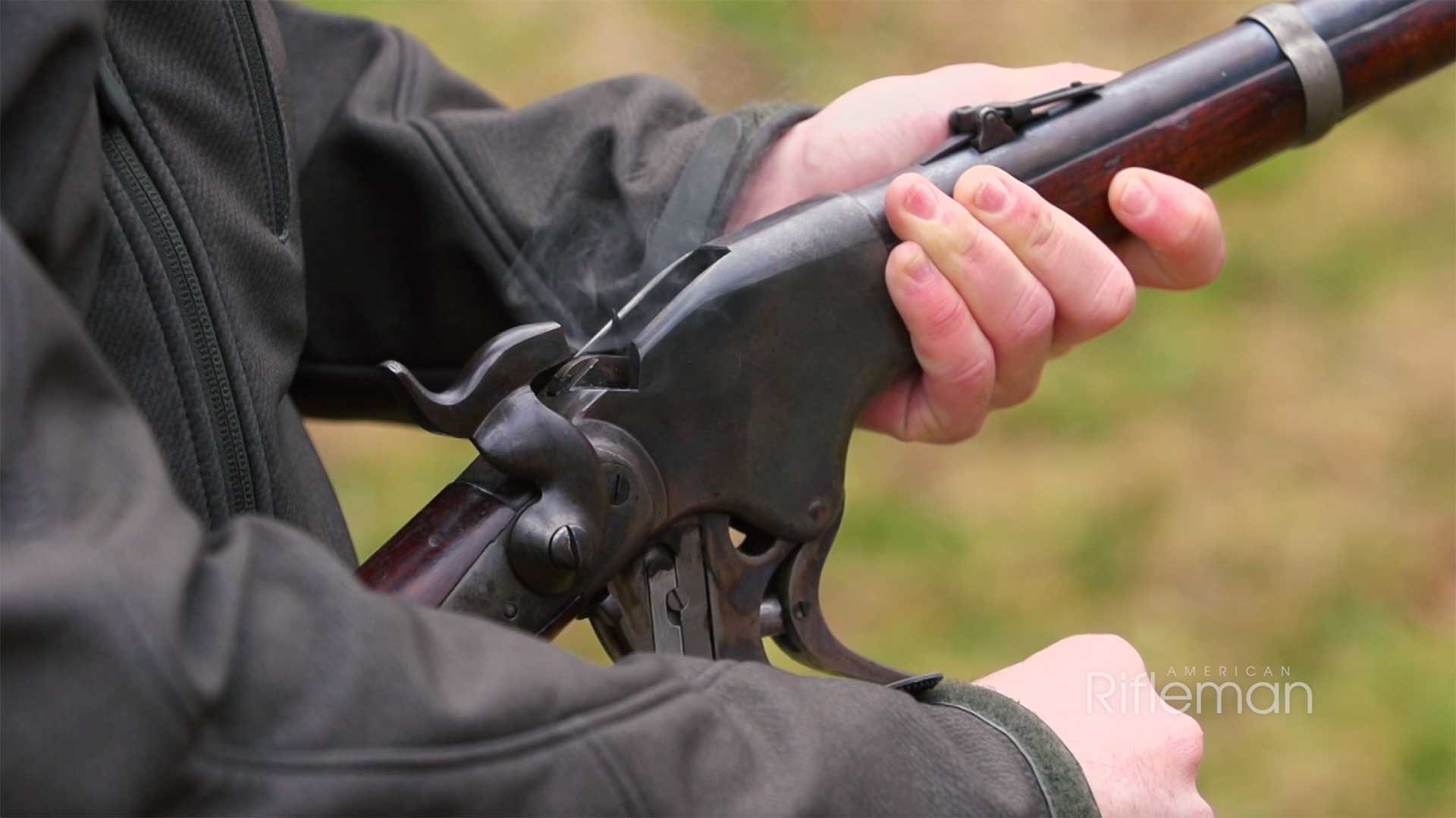 Man operating a Model 1860 Spencer carbine on an outoor range.
