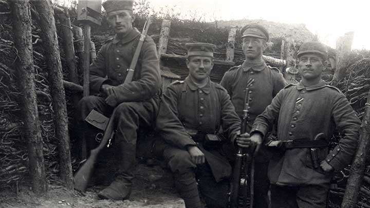 German soldiers in a trench, the soldier in the background has an extended 25 round &quot;trench magazine&quot;  fixed to his Gew 98.