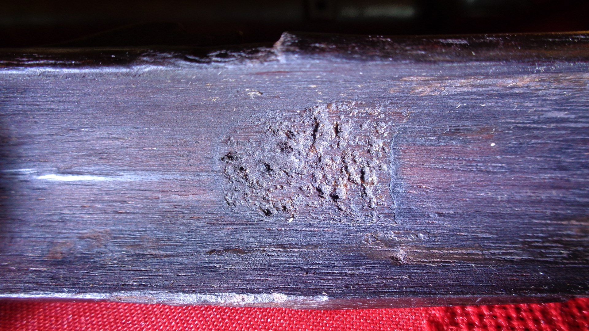 The little rectangle of disintegrating paper (with the initials “JH” on it) had been glued in the rifle stock’s barrel channel on an area that, over time, had deteriorated from the bacteria in the animal hide glue. When first noticed, it was mistaken for a splice block. Image courtesy of author.