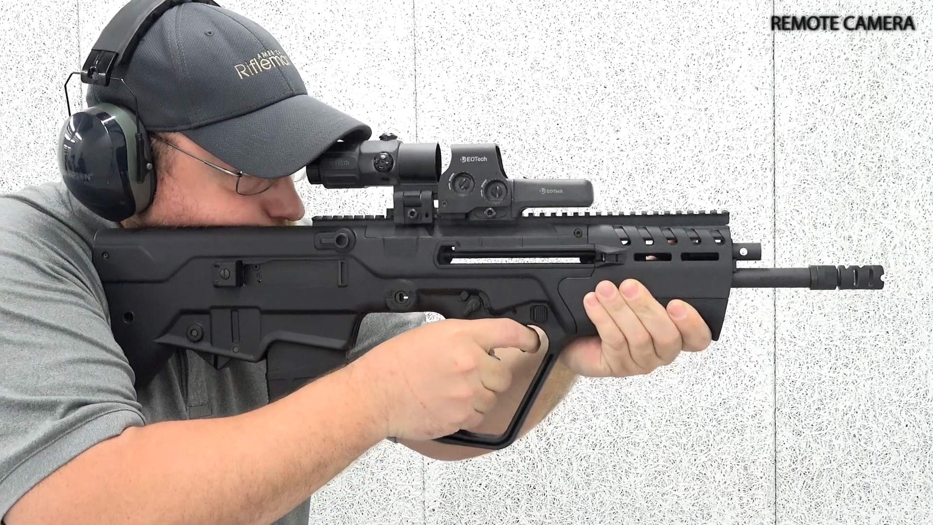 Man with IWI Tavor 7 bullpup rifle shooting gun right side view