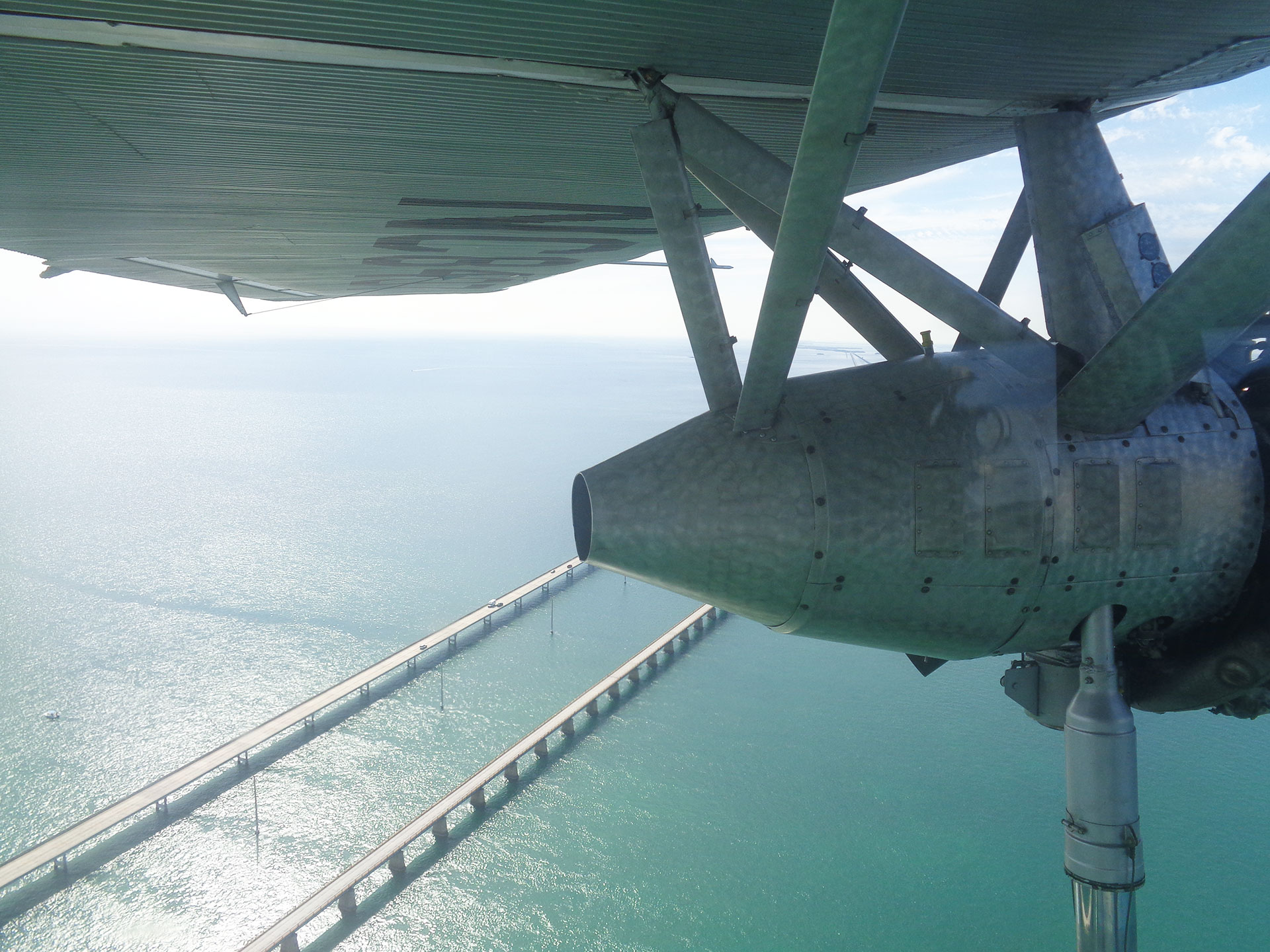 (View from Ford Tri-Motor) A view of the famed “Seven Mile Bridge” in the Florida Keys from the passenger compartment of the Ford Tri-Motor aircraft that Coates flew in Cuba.