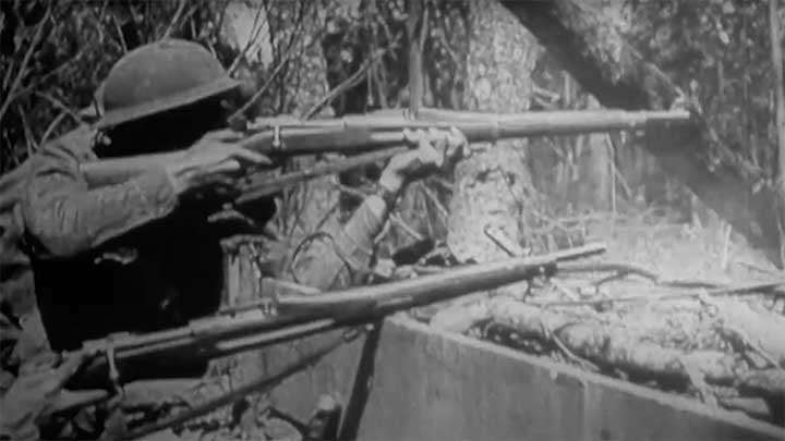 A U.S. soldier taking aim with his Springfield M1903 rifle during World War I.