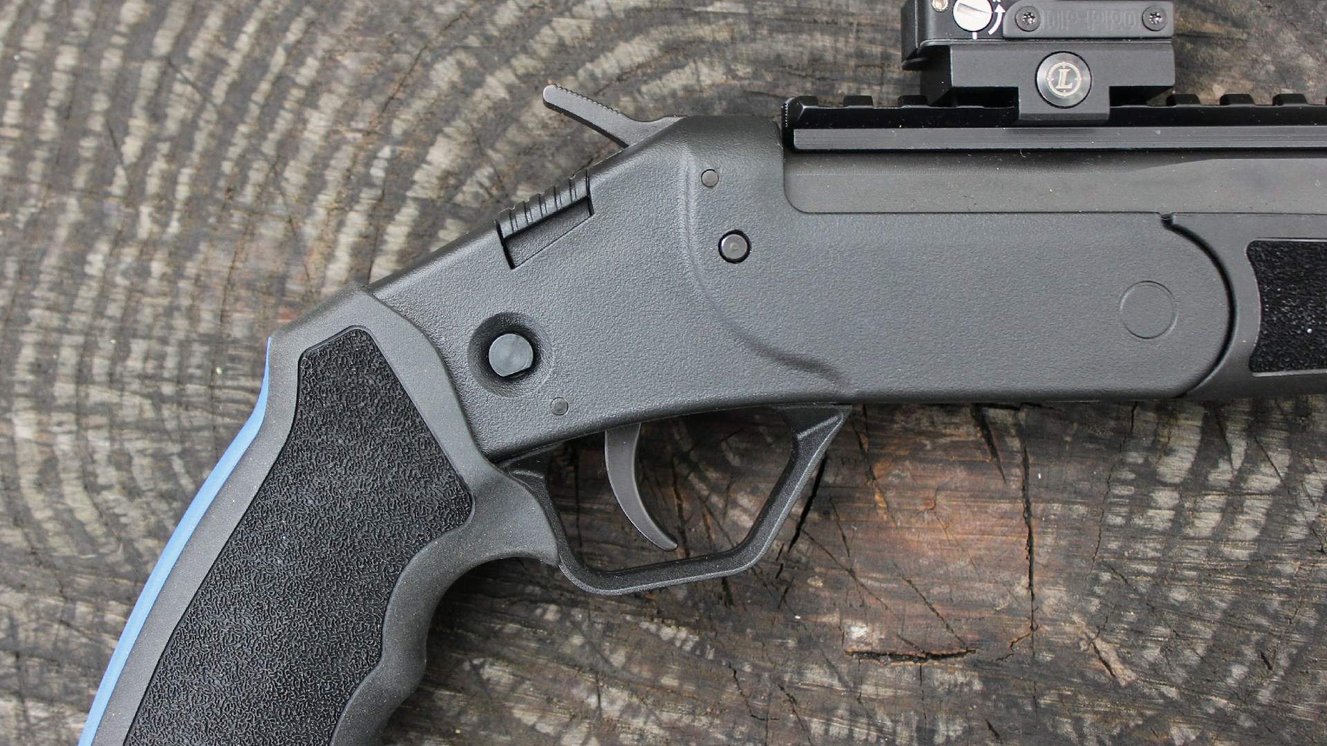 close-up right-side view of rossi brawler handgun controls buttons trugger hammer safety shown on log wood rings