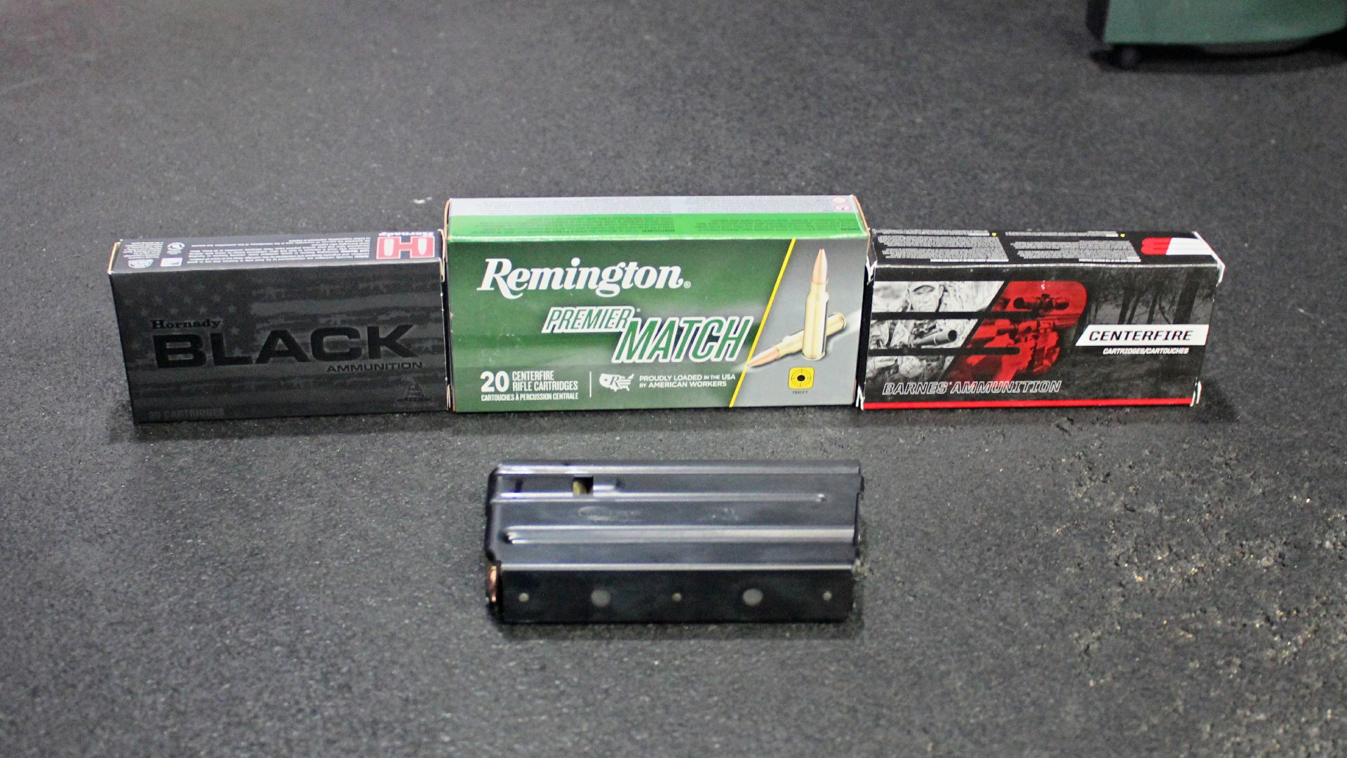 Three boxes of 223 remington ammunition shown with FM Products Rancher Rifle detachable box magazine