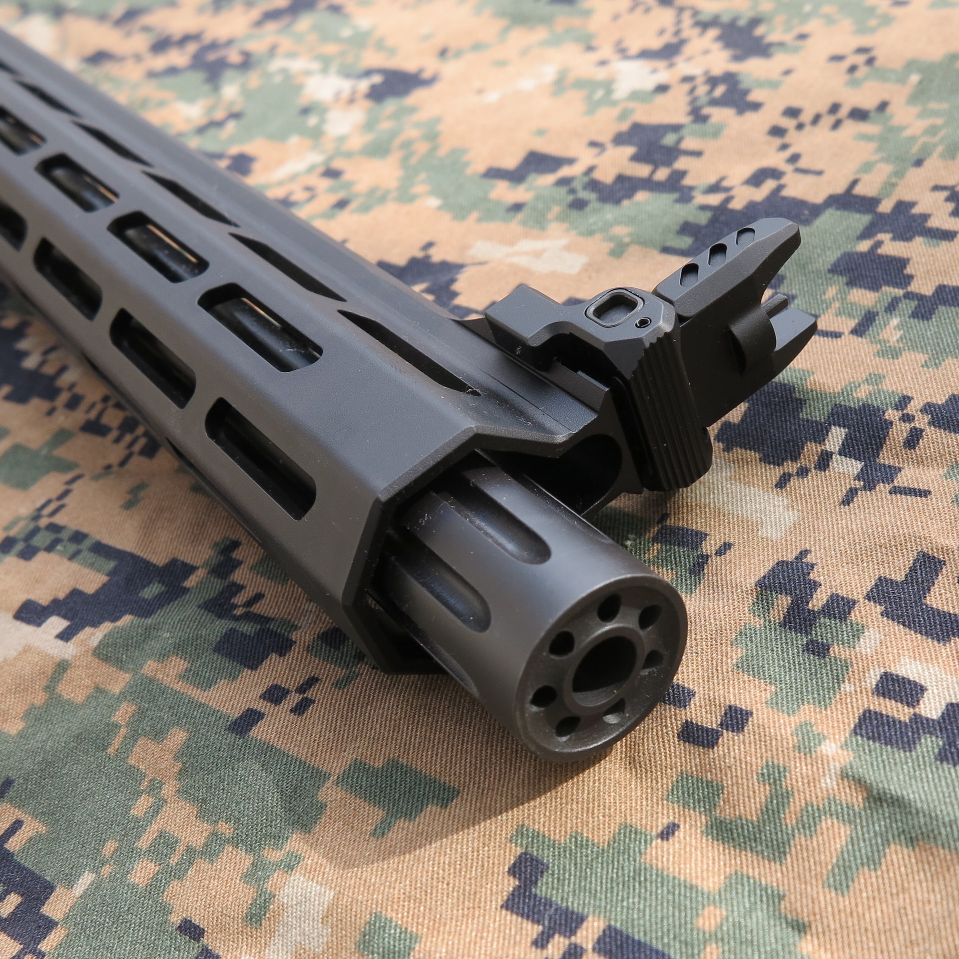 Springfield Armory Saint Victor PCC 9 mm barrel muzzle details closeup sights forward blast diverter camouflage fabric background