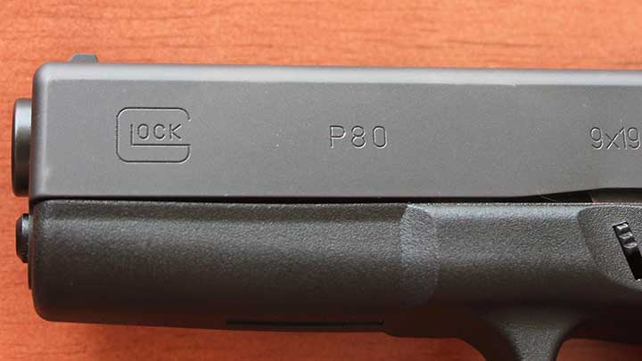 Roll marks on the slide of the Glock P80, note the lack of an accessory rail on the dust cover.