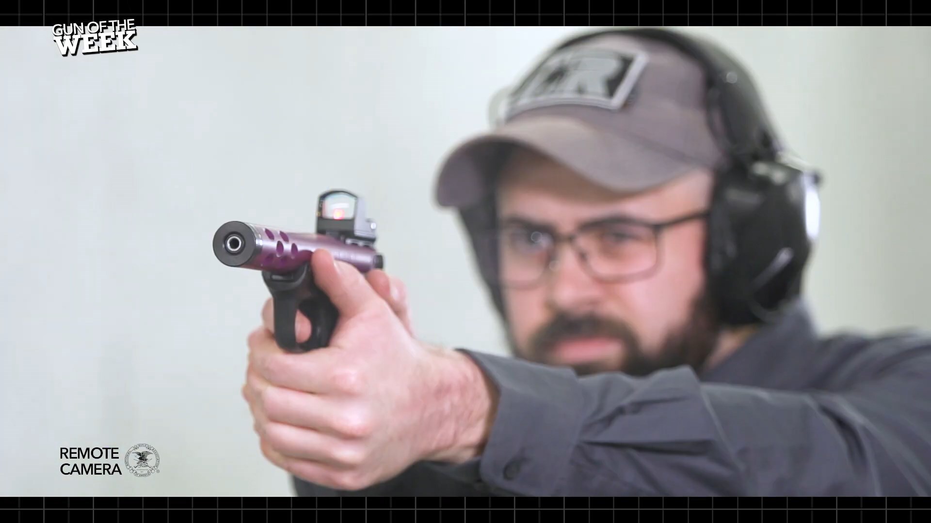 Man shooting purple handgun pistol 22LR indoors Ruger 22/45 Mk IV Lite Davidson's Exclusive gun