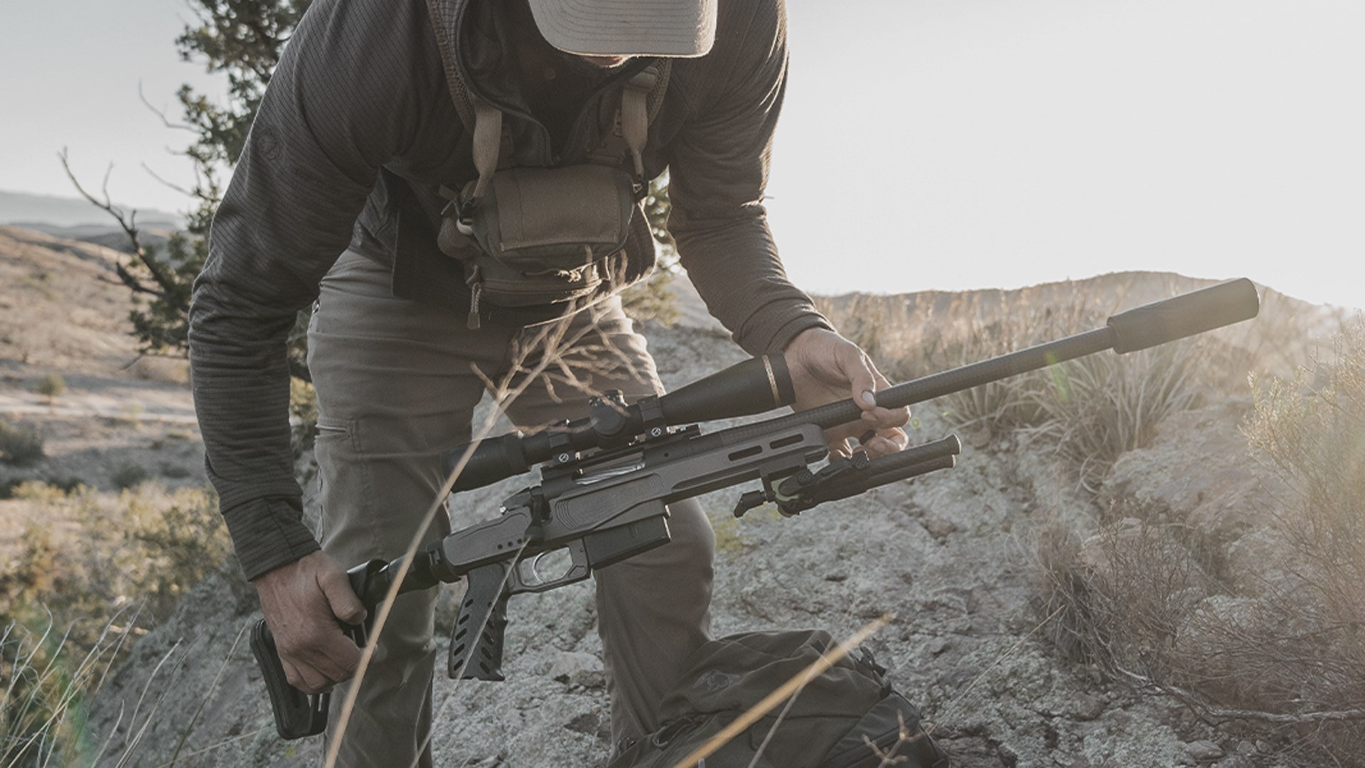 Man folding the stock of the Bergara MgMicro Lite rifle while in the field.