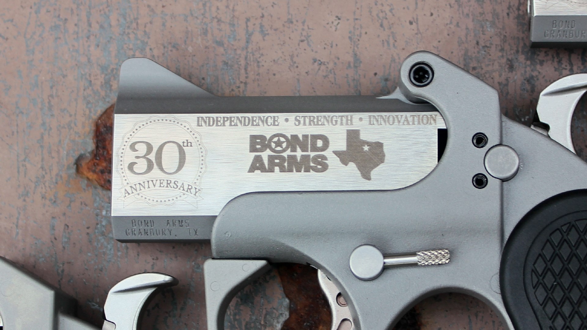 Engravings on the left side of the Bond Arms 30th Anniversary derringer.
