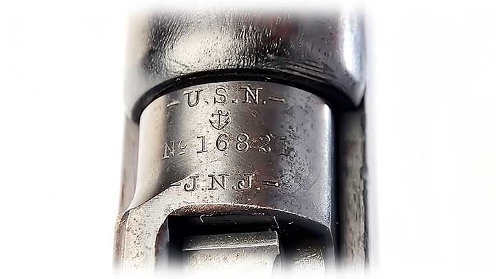 Close-up of the receiver ring on the Model 1895 Lee Navy, which shows the U.S. Naval markings; on white