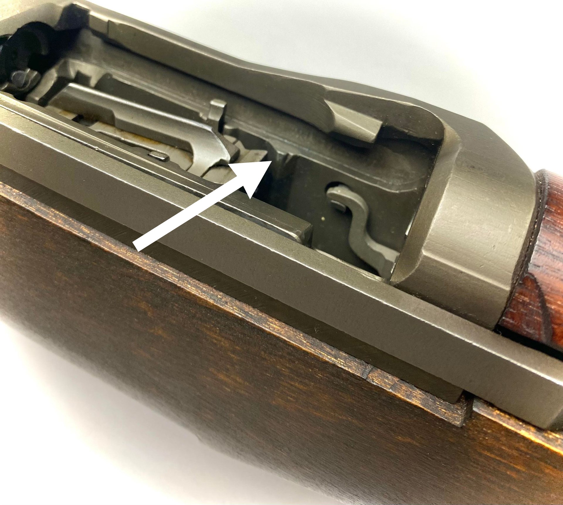 The modification (arrow) on the inside of the receiver showing the modification to fix the “7th round stoppage.” The discoloration on the “rib” showing where extra metal was welded to fix that problem