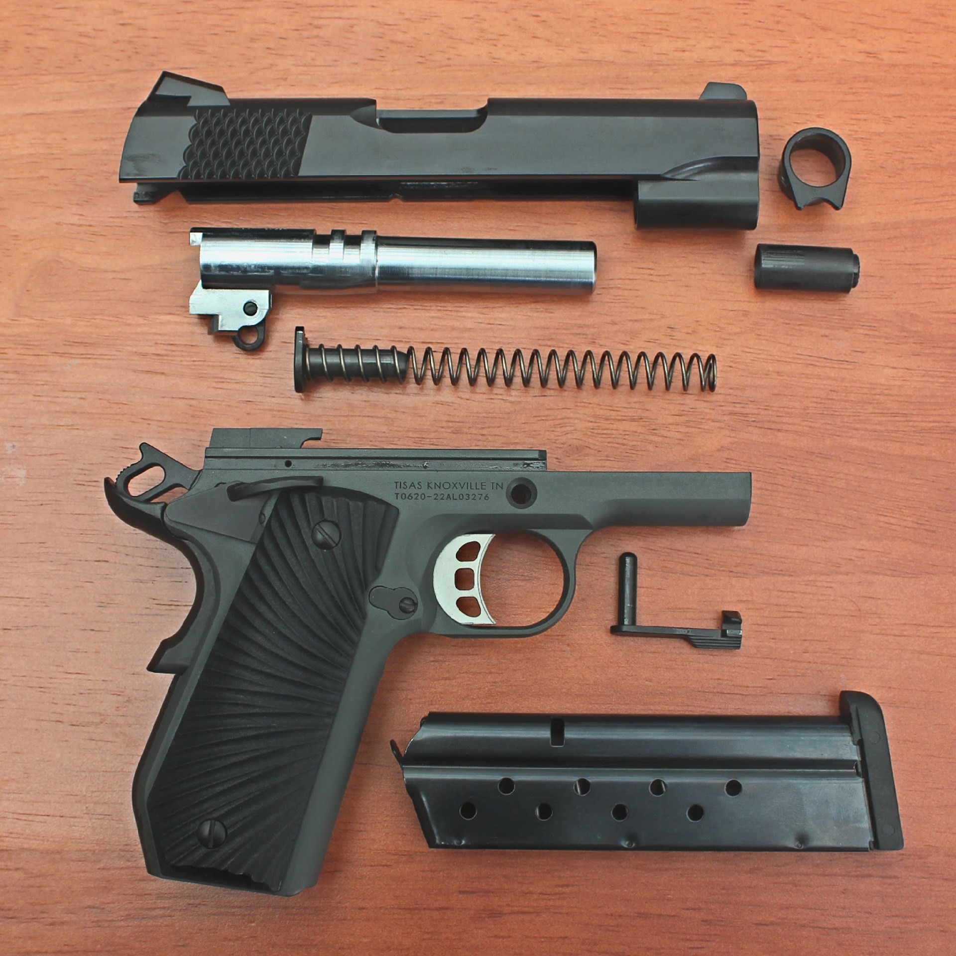 Exploded parts view disassembled arrangement 1911 tisas stingray gun pistol handgun frame slide barrel spring magazine