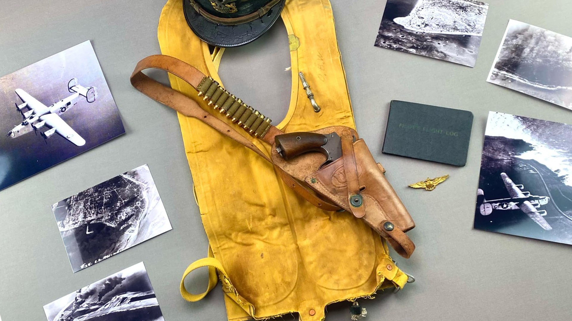Smith & Wesson Victory revolver in leather holster with bandolier ammunition life vest cap wings and photographs of aircraft