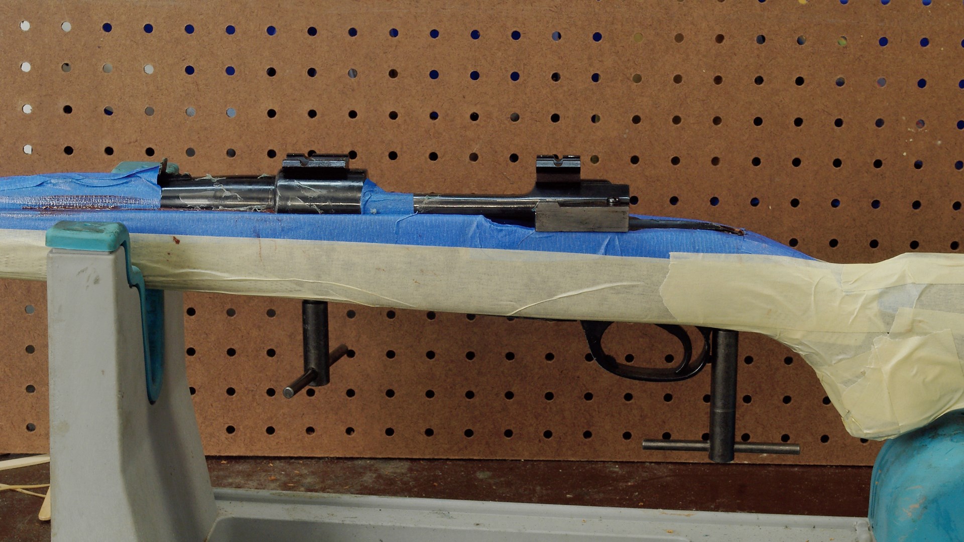 rifle stock masked with tape for bedding process