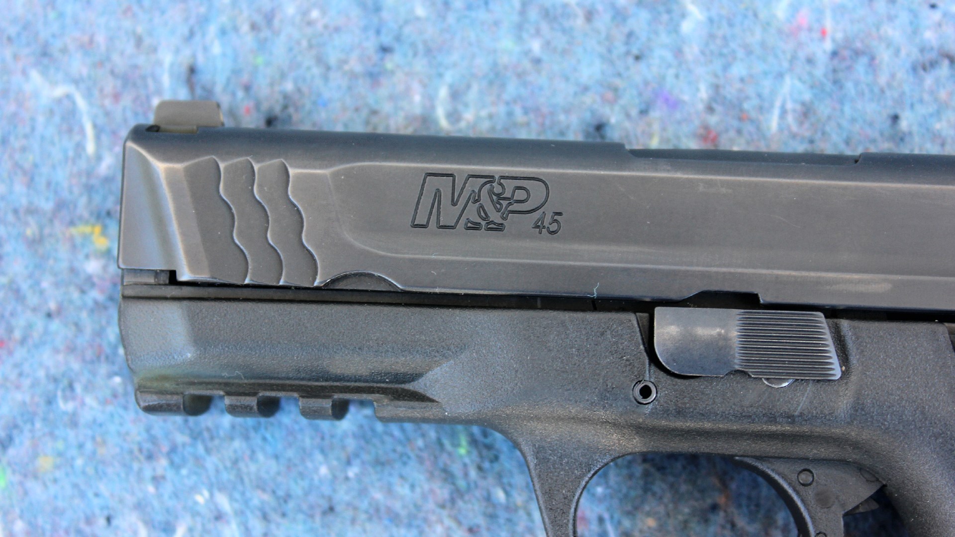 Smith & Wesson M&P 45 pistol closeup view muzzle slide black metal stamping Picatinny rail accessory rail takedown lever
