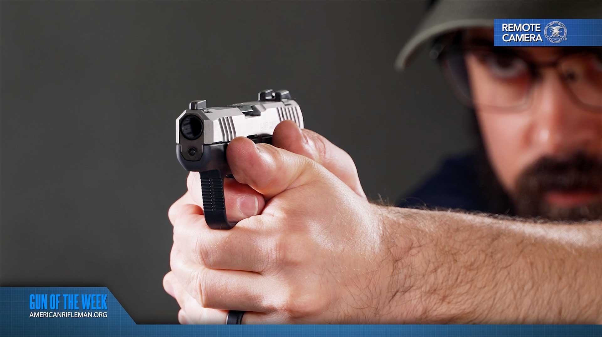 Man aiming a Ruger LCP MAX with a manual safety.
