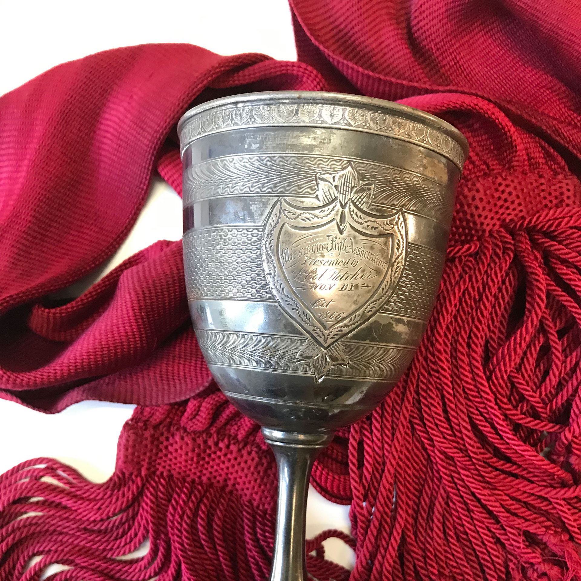 A shooting trophy of the “Red Sashes” with the sash worn by Levi Whitman of the MHG. Marksmanship training was critical to the Canadians’ success at Eccles Hill. Courtesy of Jean Plamadon.