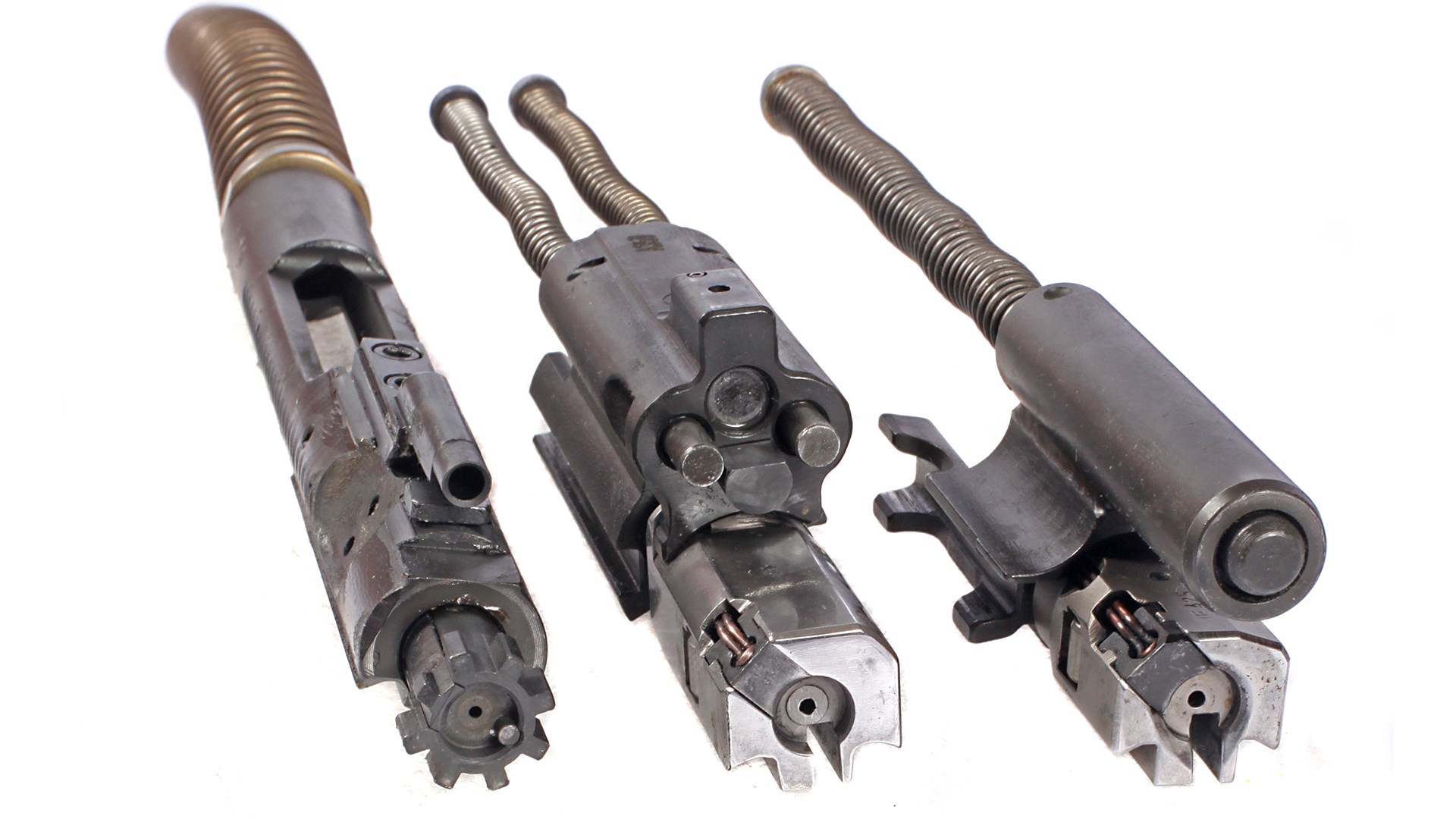 Zenith firearms ZF-56 bolt-carrier group compared to AR-15 and MP5 bolts metal springs left and right shown on white