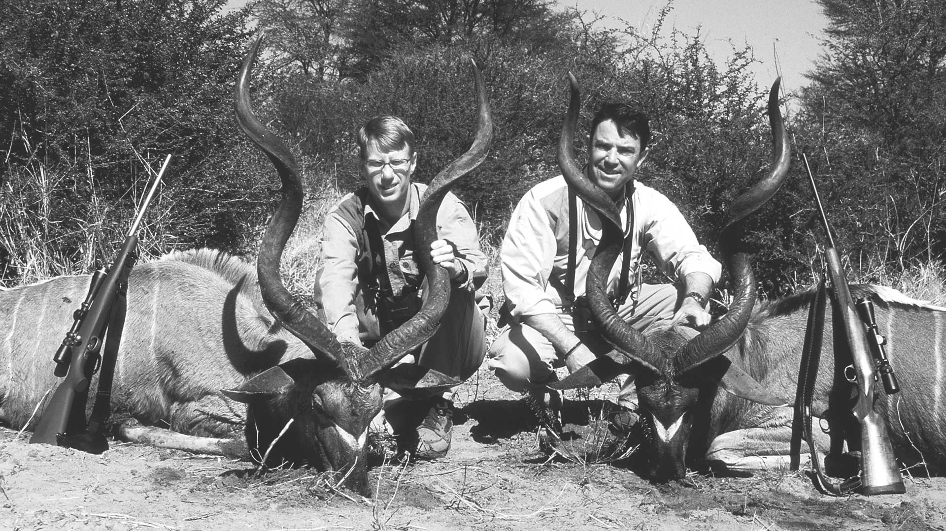 two men hunters rifles kudu bulls africa outdoors
