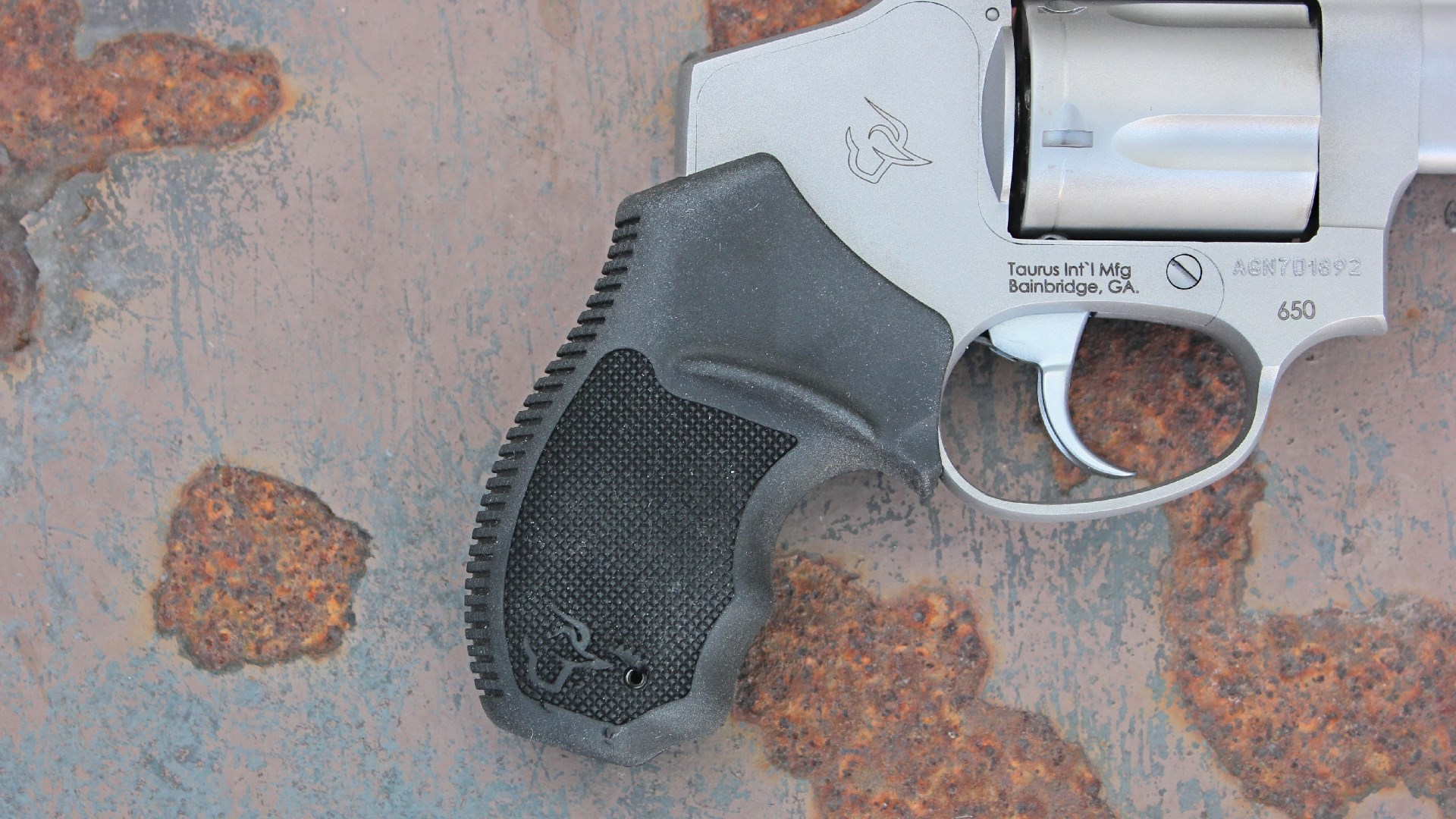 Right side of the black rubber grip on the Taurus 605 revolver.