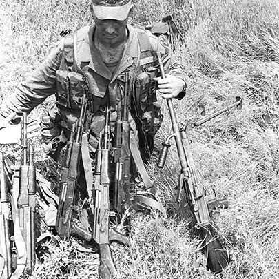 A U.S. Ranger poses with a haul of AK-47s and a Czech vz. 52/57 light machine gun (7.62x39 mm).  The vz. 52/57 used either metallic link belts or 25-round box magazines interchangeably.  Its cyclic rate was 1,100 rounds-per-minute.