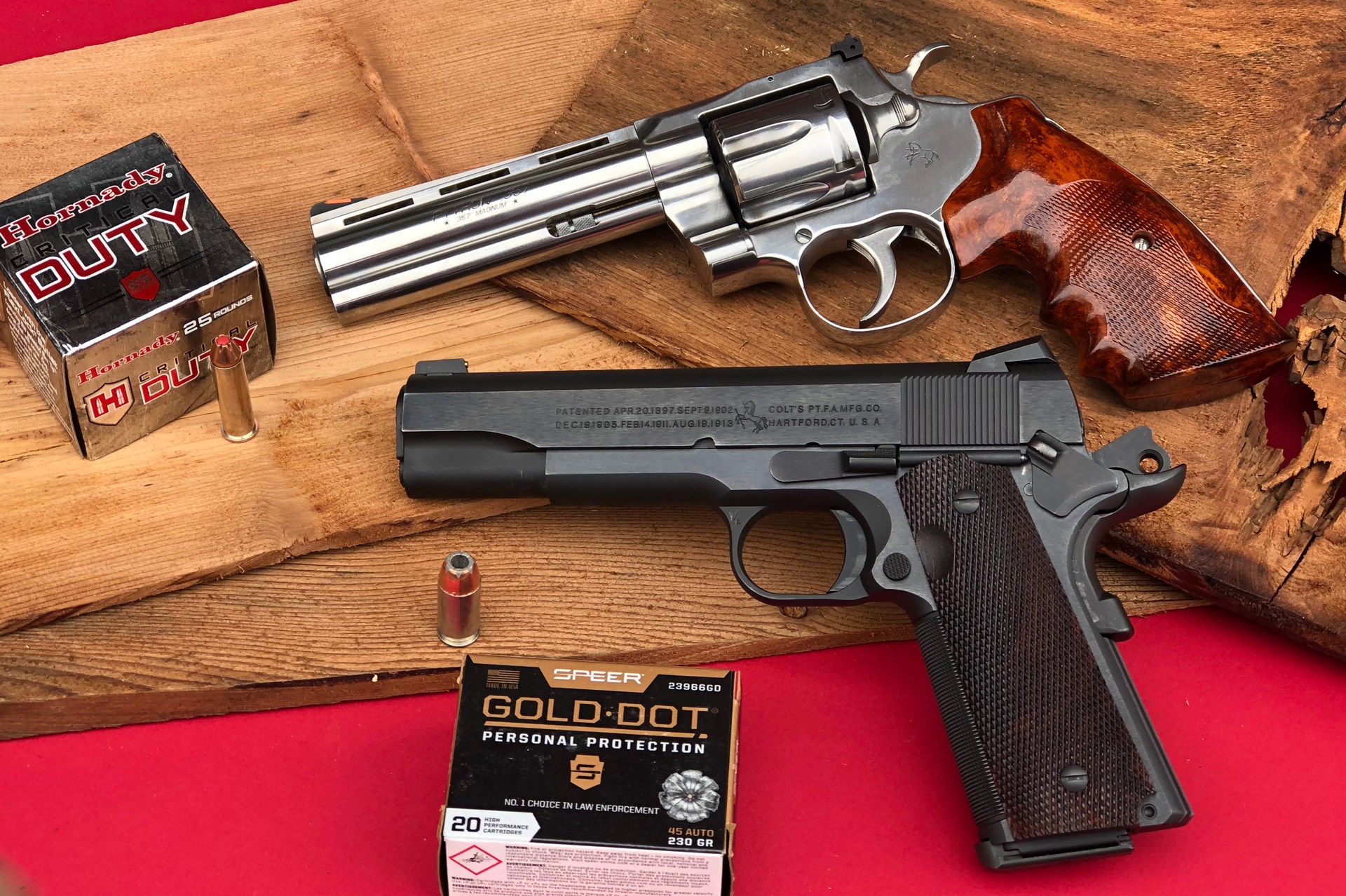Colt Python 1911 ammunition box wood background red table