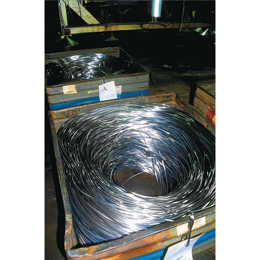 Just two of numerous coils of lead wire from which slugs are chopped for use as core material.