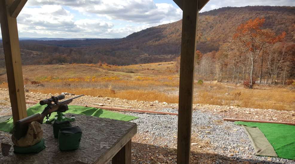 range-at-peacemaker-looking-over-rifle.jpg