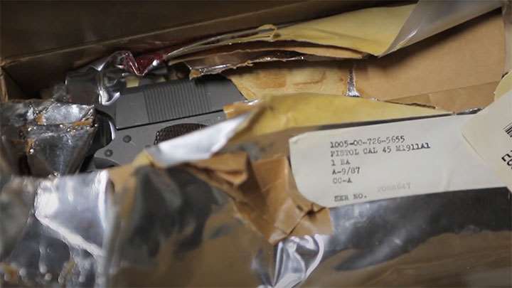 A rearsenaled M1911A1 pistol fresh inside the wrapper and box.
