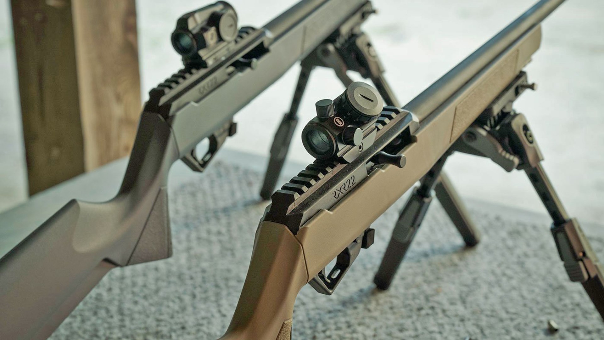 Top view of two Savage Arms RXR22 rifles with optics attached.
