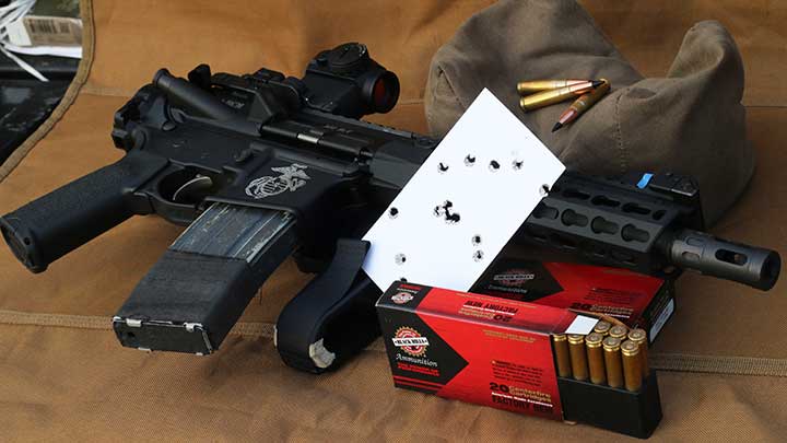 An AR-15 pistol used in the 3x5 drill with the results on the card.