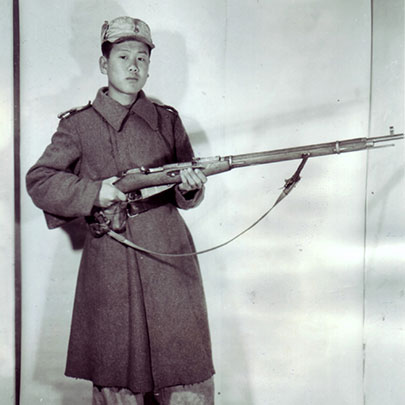 Before the war:  A North Korean border guard poses with a Mosin-Nagant M1891/30 rifle (7.62x54 mm R).