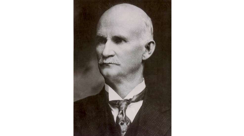 Portrait of John Moses Browning man in suit and tie looking left black and white vintage photograph