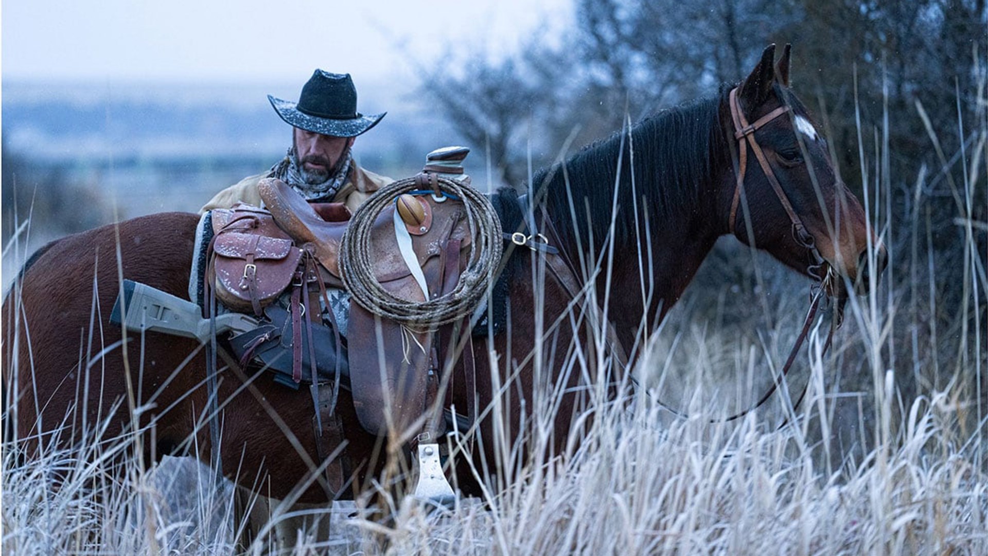 SIG Sauer MCX Regulator in a scabbard on the side of a horse, with tall grass in the foreground.